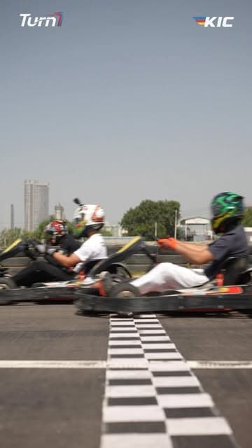Karts crossing the start line at Turn 1