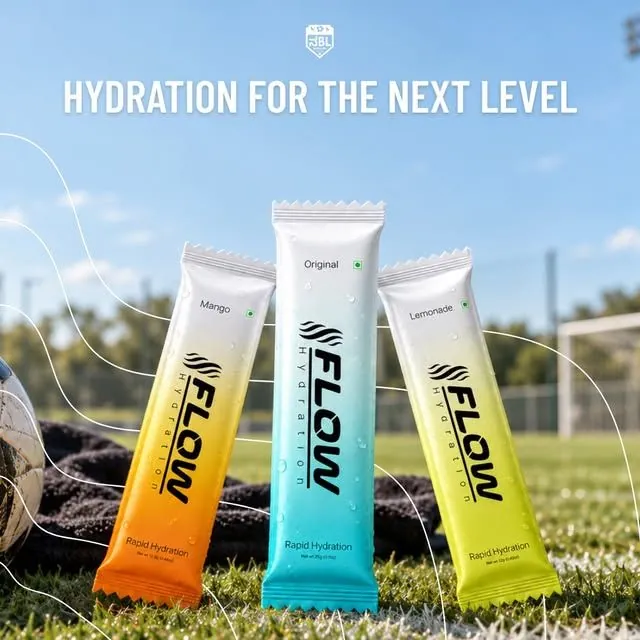 Flow Original, Mango and Lemonade electrolyte sachets standing on a football pitch at the Namma Bengaluru League